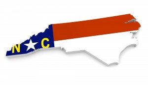 3D geographic outline map of North Carolina with the state flag