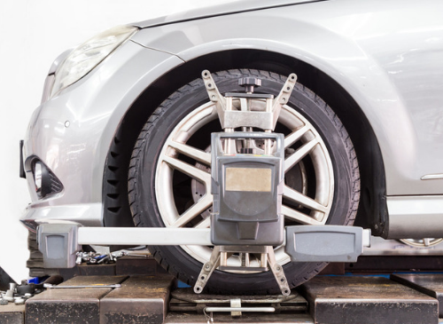 Photo of an alignment machine clamped to tire